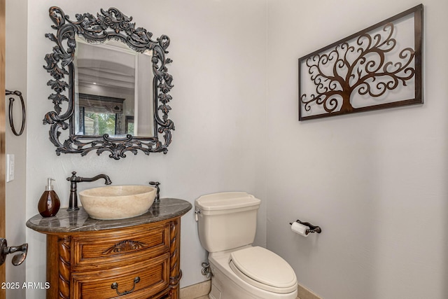 bathroom featuring toilet and vanity