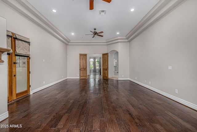 interior space with ceiling fan, dark wood-type flooring, and ornamental molding