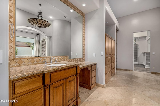 bathroom featuring vanity and backsplash