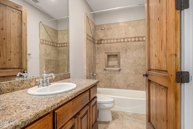 full bathroom with toilet, vanity, and tiled shower / bath