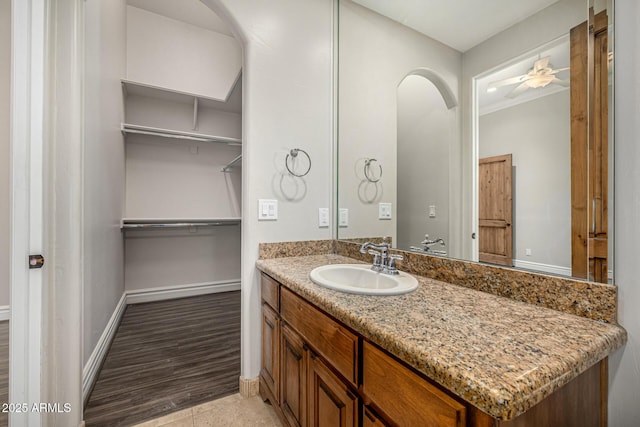 bathroom with ceiling fan, vanity, tile patterned floors, and ornamental molding