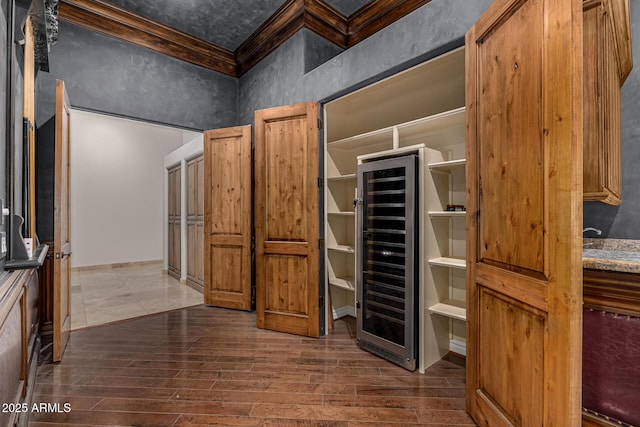 spacious closet with dark wood-type flooring and wine cooler