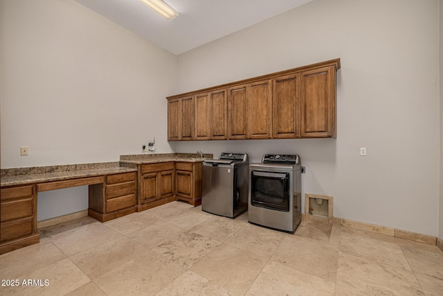 laundry room featuring independent washer and dryer and cabinets