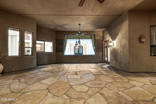 foyer entrance featuring ceiling fan