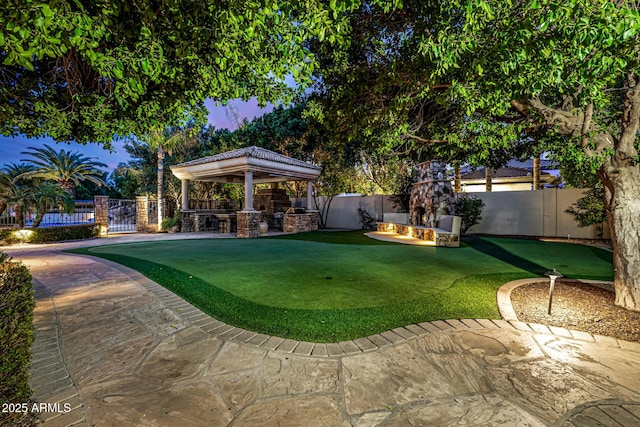 view of yard featuring an outdoor fire pit, a gazebo, and a patio area