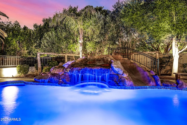 view of pool at dusk