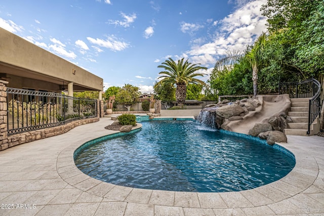 view of swimming pool featuring pool water feature and a patio area