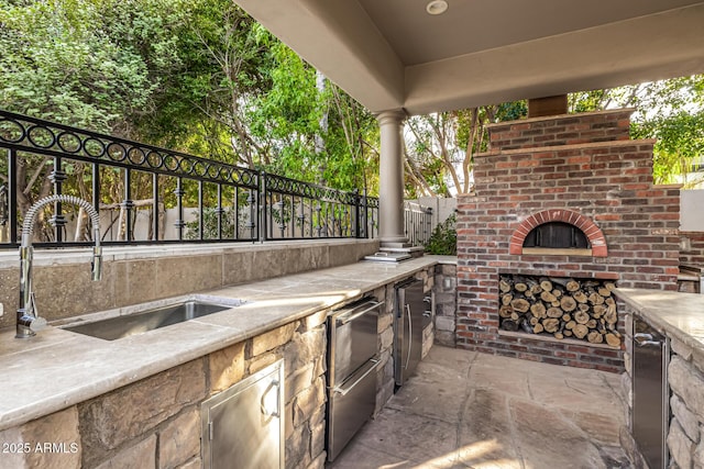 view of patio / terrace with exterior kitchen and sink