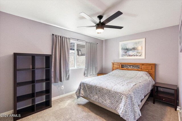 bedroom with a ceiling fan, carpet flooring, and baseboards