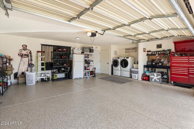 garage with a garage door opener, a workshop area, separate washer and dryer, and freestanding refrigerator