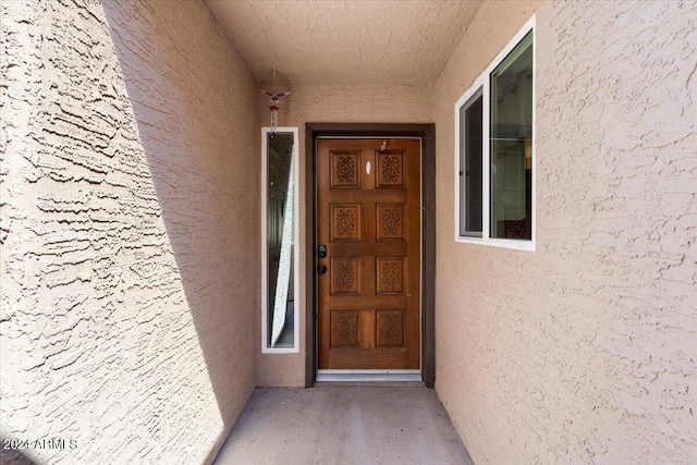 property entrance with stucco siding