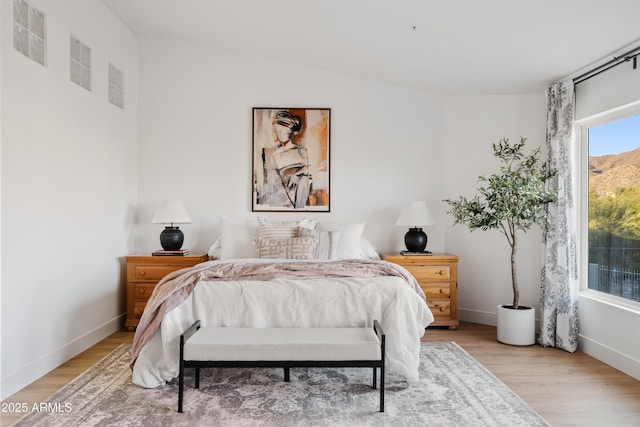 bedroom with baseboards and light wood-style floors