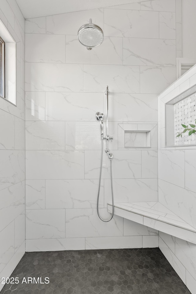 full bath with a tile shower