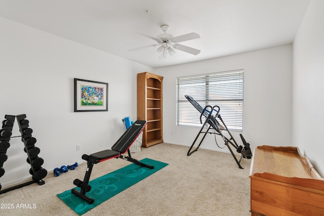 workout room featuring carpet flooring, baseboards, and a ceiling fan