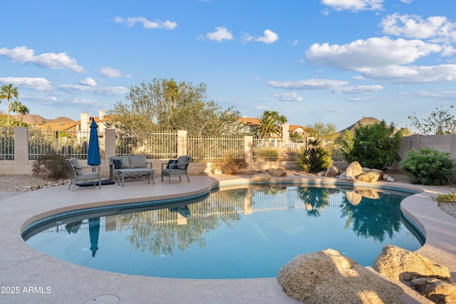 view of swimming pool featuring a fenced in pool, a fenced backyard, and a patio area