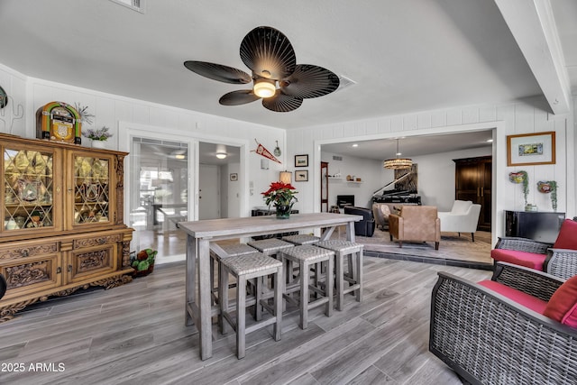 dining room with ceiling fan and light hardwood / wood-style flooring