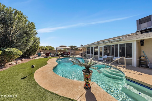 view of pool featuring a gazebo, a yard, a sunroom, and a patio