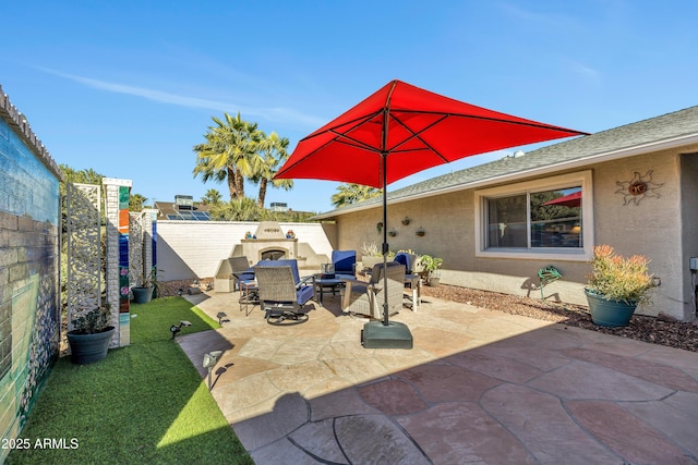 view of patio with an outdoor fireplace