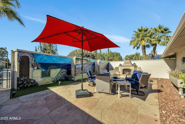 view of patio / terrace featuring an outdoor fireplace