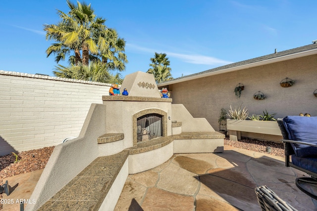 view of patio / terrace with a multi sided fireplace