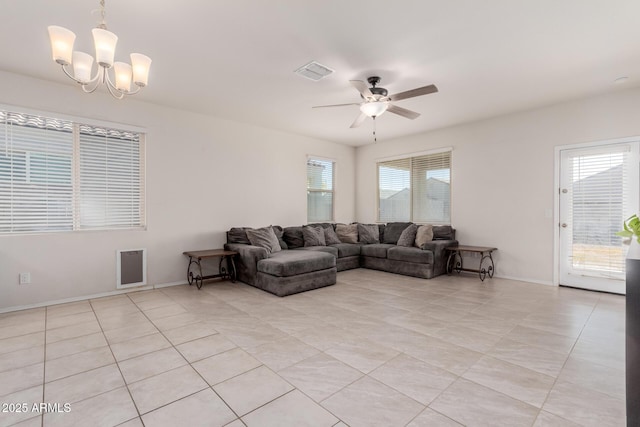 living room featuring ceiling fan with notable chandelier and light tile patterned flooring