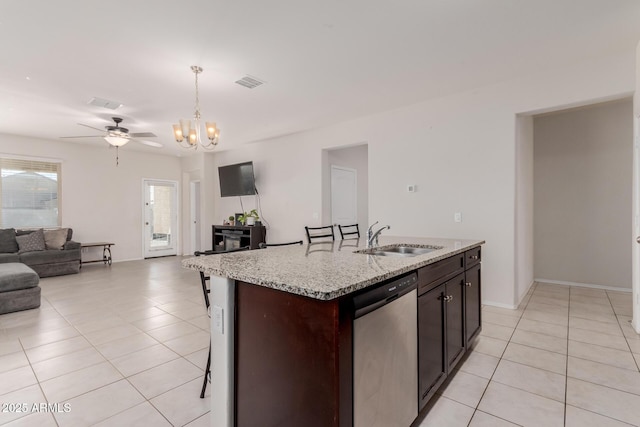 kitchen with dishwasher, hanging light fixtures, a center island with sink, a breakfast bar, and sink