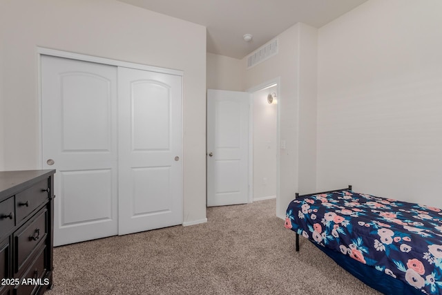 bedroom with a closet and light carpet