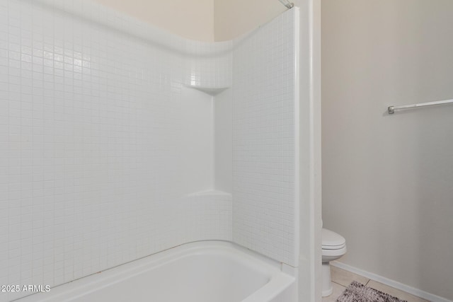 bathroom with toilet and tile patterned floors