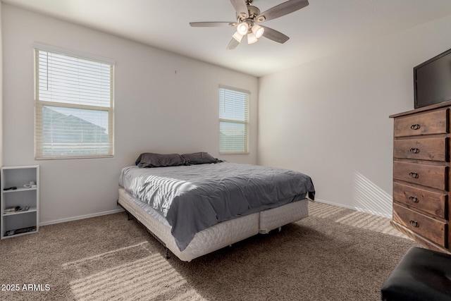 carpeted bedroom with ceiling fan and multiple windows