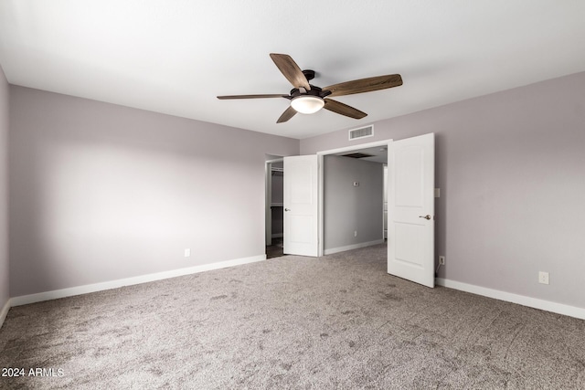 unfurnished bedroom with a ceiling fan, carpet flooring, visible vents, and baseboards