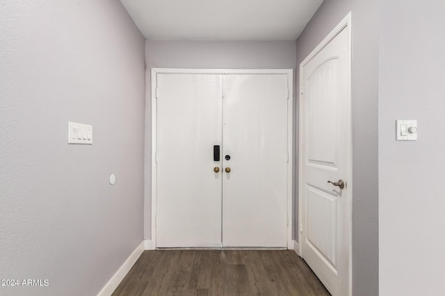 doorway to outside featuring dark wood finished floors and baseboards