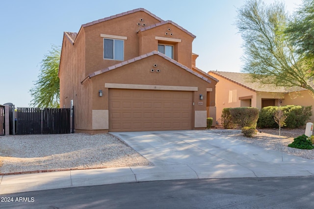 18359 W Eva St, Waddell, AZ 85355 - view of front facade with a tiled roof, stucco siding, concrete driveway, a gate, and an attached garage