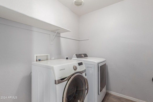 18359 W Eva St, Waddell, AZ 85355 - washroom featuring wood finished floors, baseboards, and washer and clothes dryer