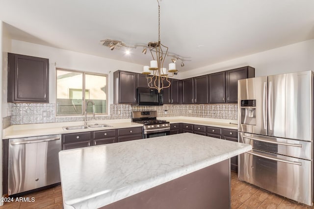 18359 W Eva St, Waddell, AZ 85355 - kitchen featuring appliances with stainless steel finishes, a sink, a chandelier, light countertops, and dark brown cabinets