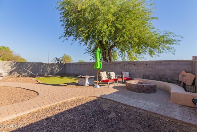 18359 W Eva St, Waddell, AZ 85355 - fenced backyard with an outdoor fire pit and a patio