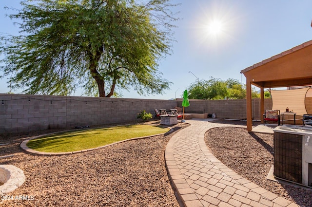18359 W Eva St, Waddell, AZ 85355 - view of yard featuring an outdoor fire pit, cooling unit, and a patio