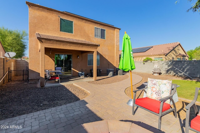 18359 W Eva St, Waddell, AZ 85355 - back of property featuring stucco siding, a fenced backyard, a patio area, a gate, and outdoor dining area