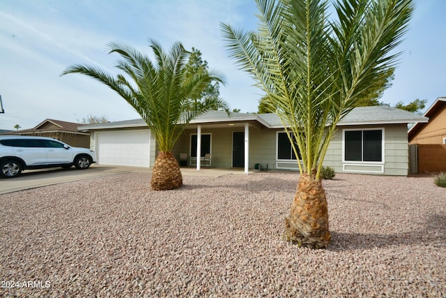 single story home featuring an attached garage and driveway