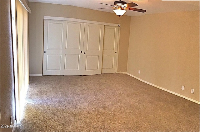 unfurnished bedroom with carpet floors, baseboards, and a closet