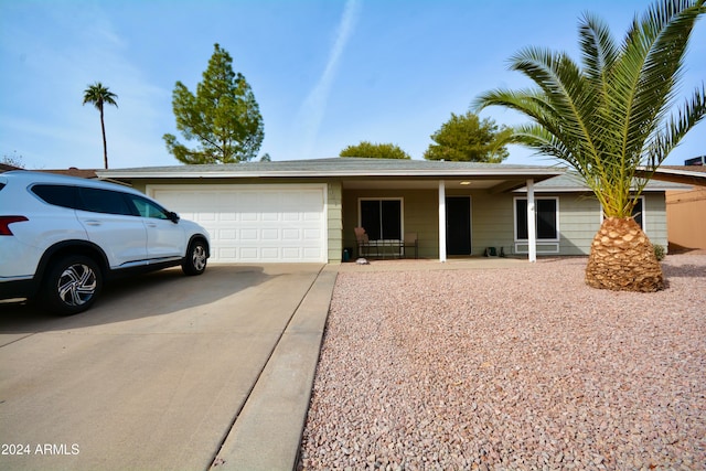 ranch-style home with driveway and an attached garage