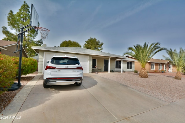 ranch-style house with an attached garage and driveway