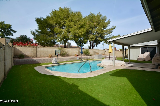 view of pool with a fenced backyard, a patio, a fenced in pool, and a yard