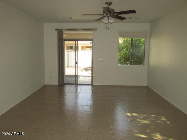 empty room featuring ceiling fan and tile patterned flooring