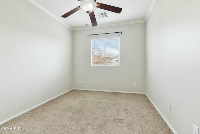 carpeted empty room featuring baseboards, visible vents, ceiling fan, and crown molding