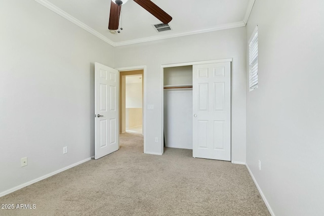 unfurnished bedroom with carpet floors, a closet, visible vents, and crown molding