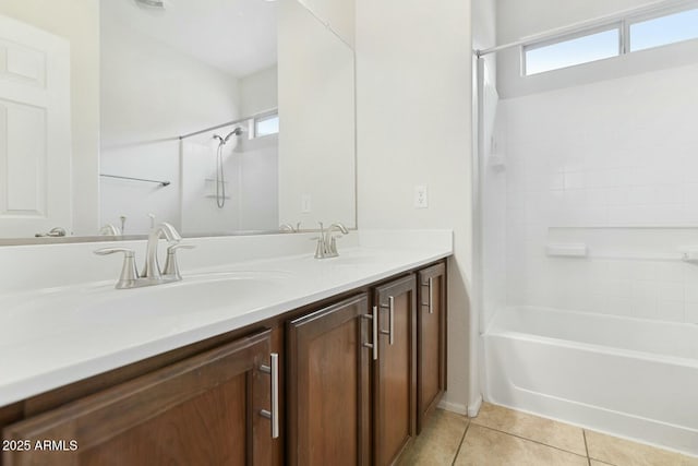 bathroom with double vanity, shower / tub combination, a sink, and tile patterned floors