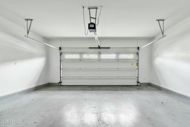 garage with a garage door opener and baseboards