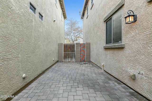 view of home's exterior featuring a gate and stucco siding