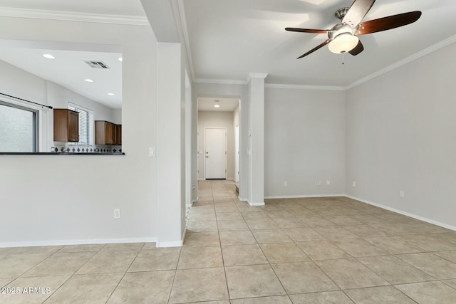 unfurnished room with baseboards, crown molding, and light tile patterned flooring