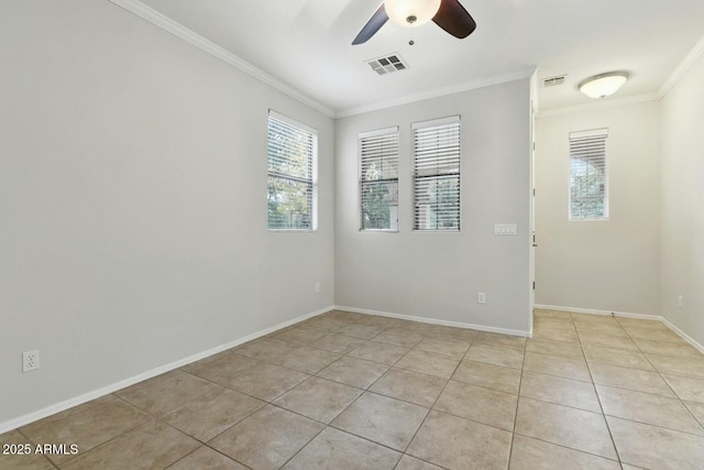 empty room with light tile patterned floors, plenty of natural light, visible vents, and ornamental molding